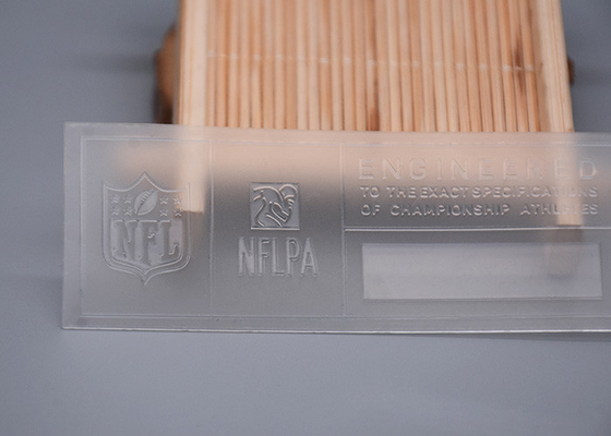 Подгонянное прозрачное TPU печатая сияющий логотип силикона для одежды